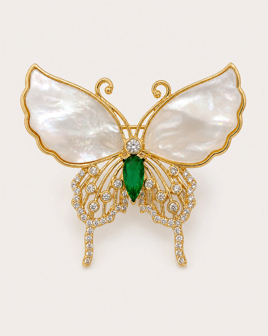 Elina Green Shell Butterfly Brooch on an exact #F0EBE9 background with directional light and a natural contact shadow.