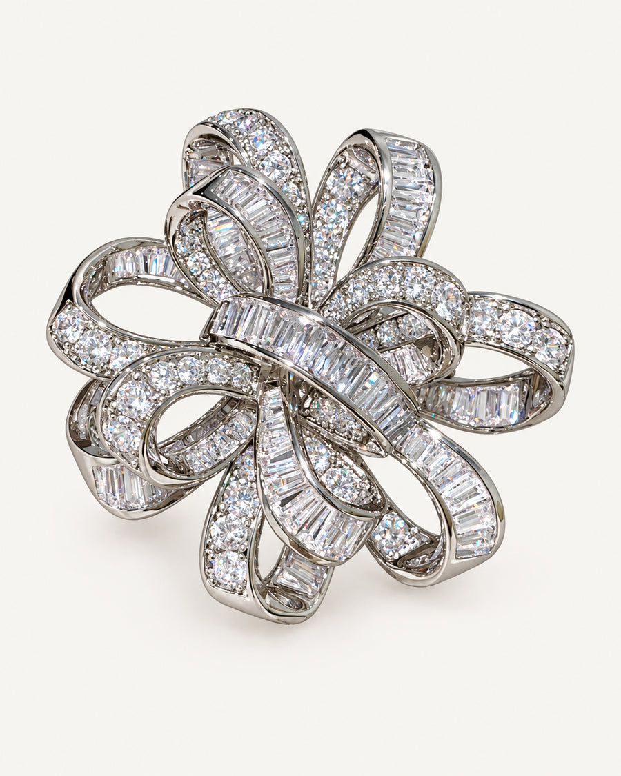 Silver-tone Elva crystal ribbon rosette brooch with interwoven pavé and baguette zircon bands