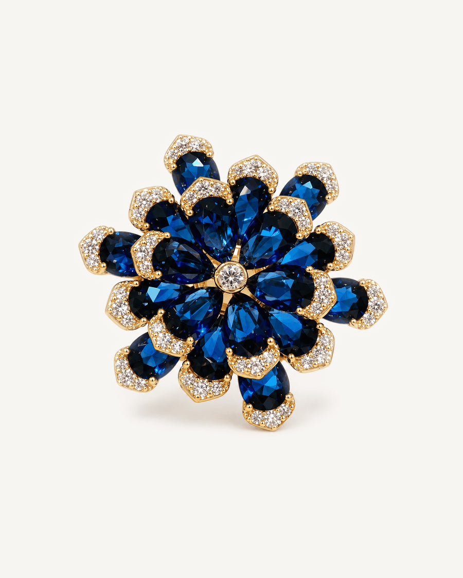 Nilla Midnight Blue Zircon Flower Brooch shown complete on a warm plain background.