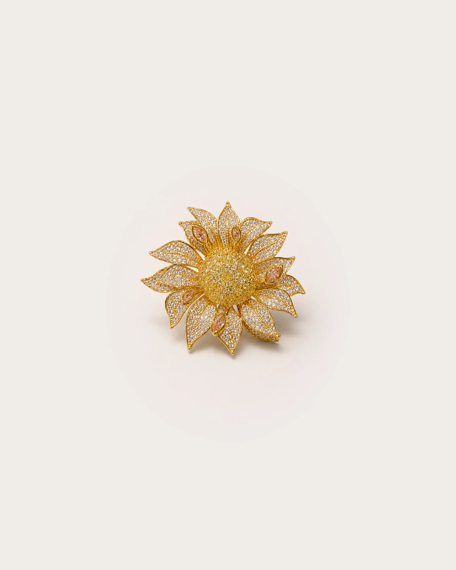 Solvi Layered Crystal Sunflower Brooch on a warm #F0EBE9 studio background with a natural contact shadow