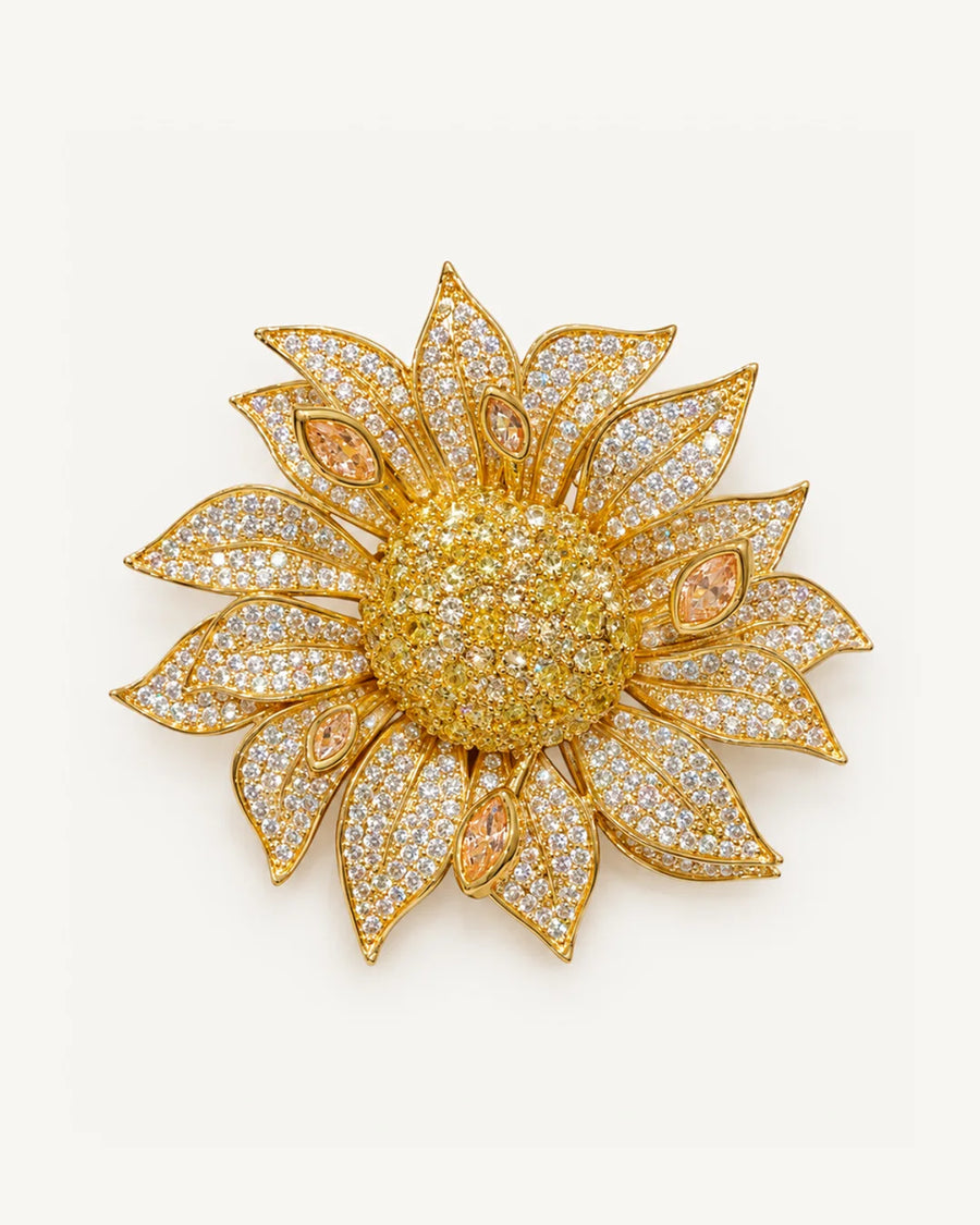 Solvi Layered Crystal Sunflower Brooch on a warm #F0EBE9 studio background with a natural contact shadow