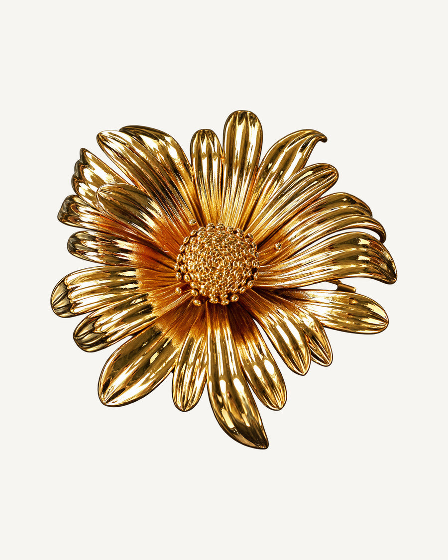 Aurinko Bloom Brooch on a soft warm grey background