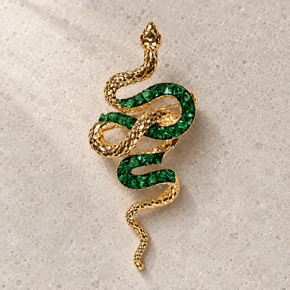 Sisu green snake brooch on warm grey stone