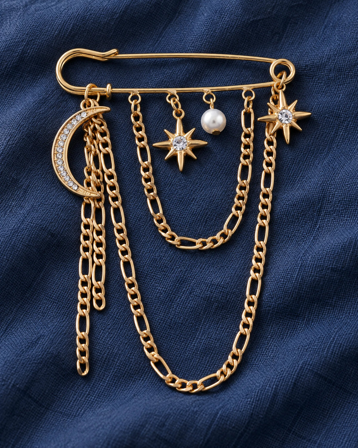 Moon and star safety pin brooch with a white bead and draped gold-tone chains