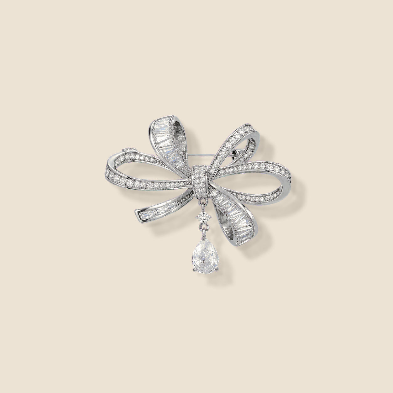 Sylvi Crystal Ribbon Brooch on an exact warm ivory background