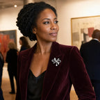 Sylvi Crystal Ribbon Brooch worn on a burgundy blazer in a gallery
