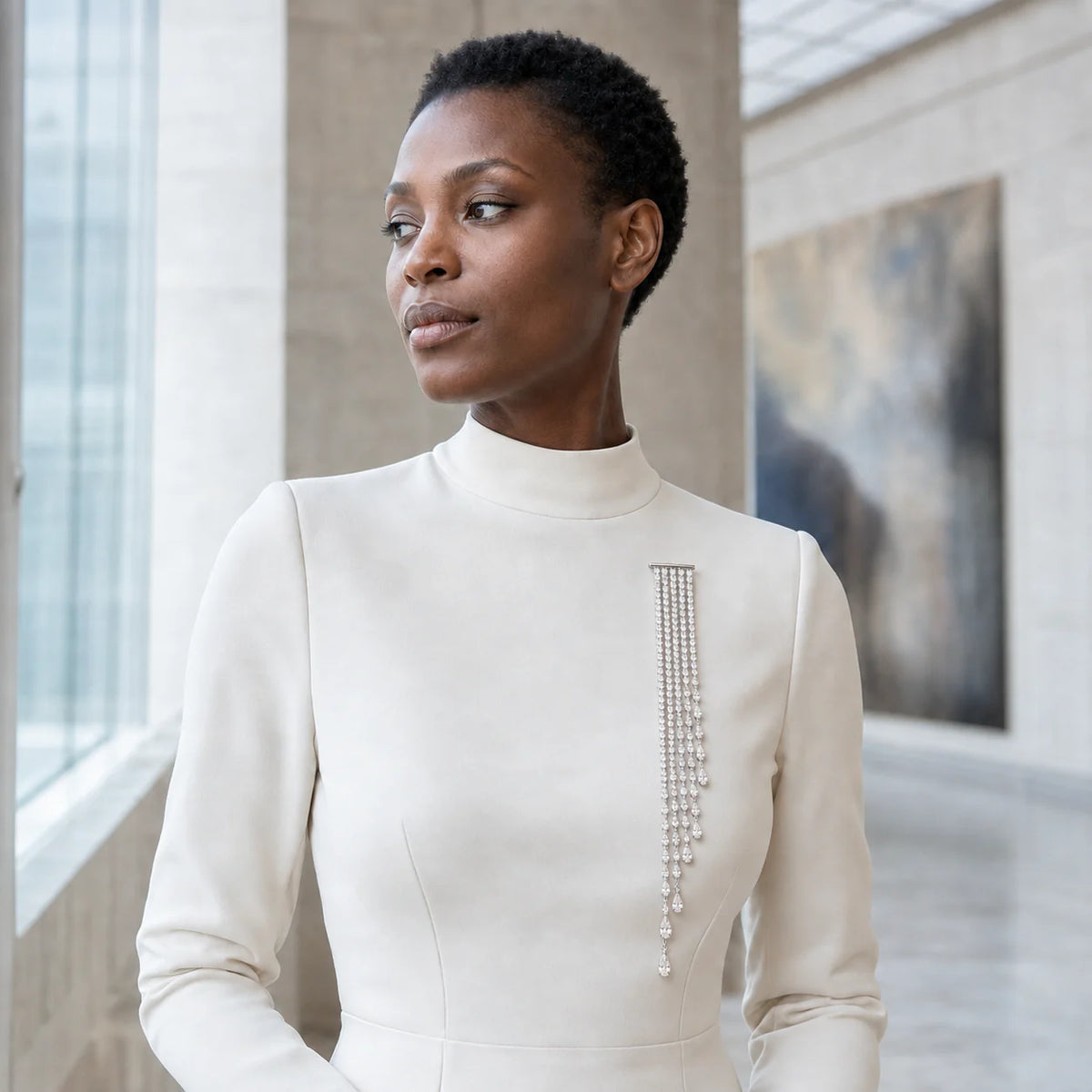 Kajo Crystal Cascade Brooch worn on a tailored lapel in a museum setting
