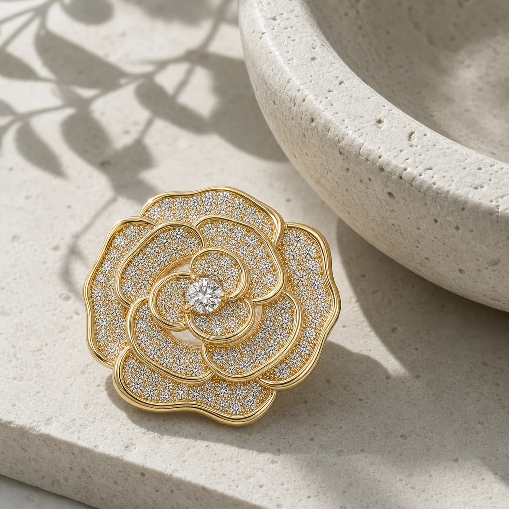 Valo Crystal Camellia Brooch displayed on pale travertine in morning light