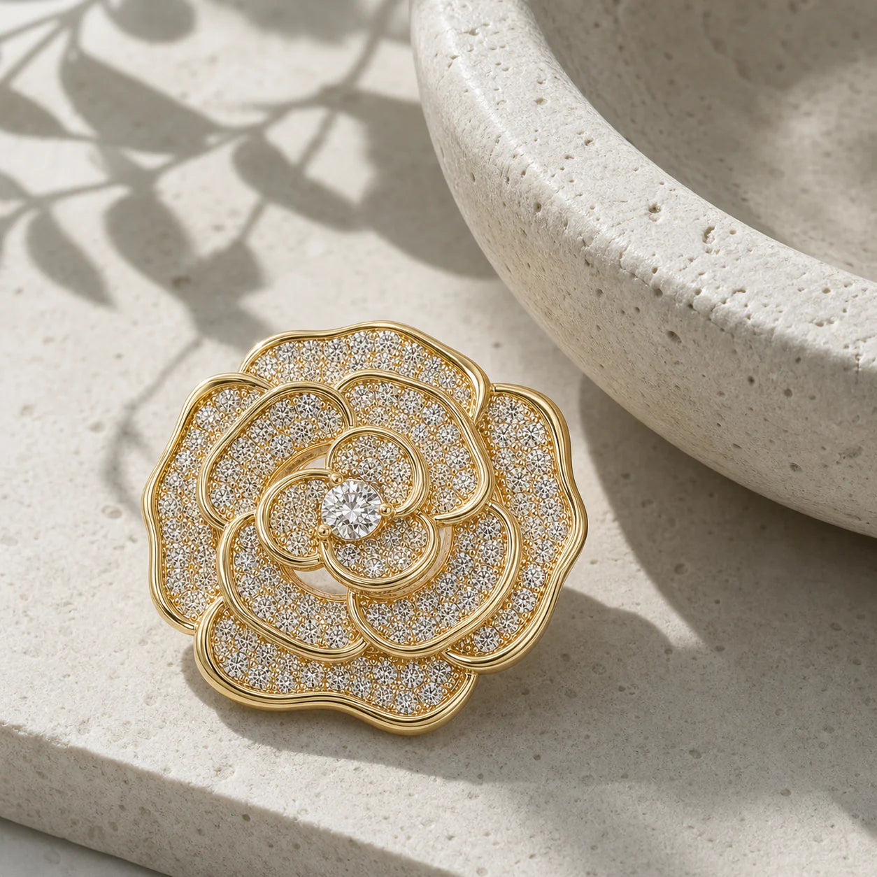 Valo Crystal Camellia Brooch displayed on pale travertine in morning light