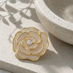 Valo Crystal Camellia Brooch displayed on pale travertine in morning light