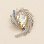 Astra Orbit Crystal Brooch on pale background