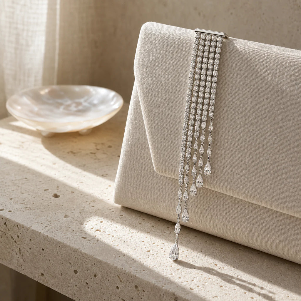 Kajo Crystal Cascade Brooch styled on an evening clutch