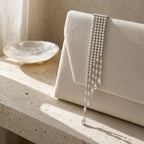 Kajo Crystal Cascade Brooch styled on an evening clutch