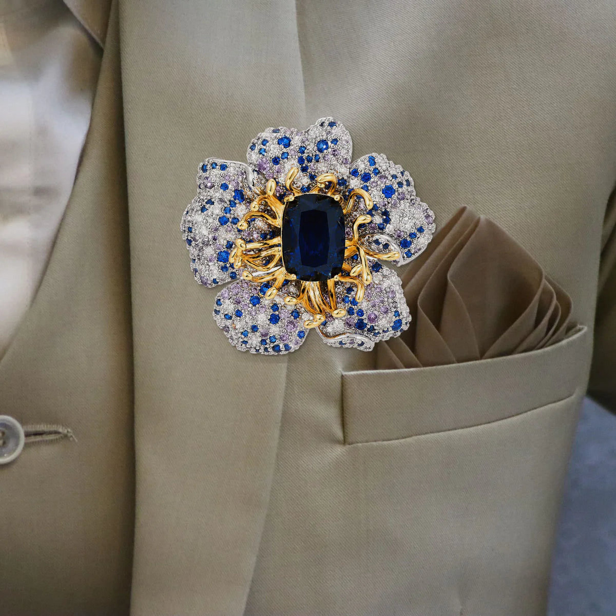 Front view of Sini Midnight Bloom Brooch pinned to a beige suit lapel