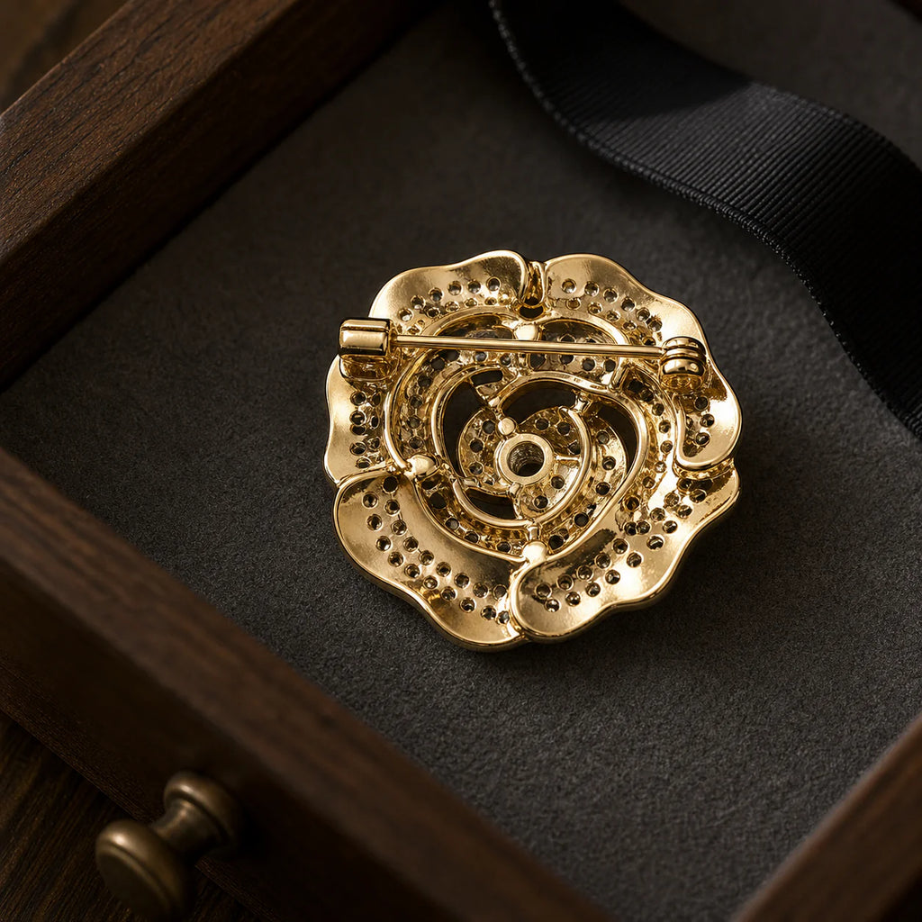 Reverse of the Valo Crystal Camellia Brooch showing its horizontal pin on charcoal suede
