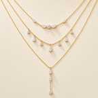 Aurelia Light layered gold crystal necklace on a warm plain background