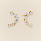 Ilo Smile Pave Stud Earrings on warm neutral background