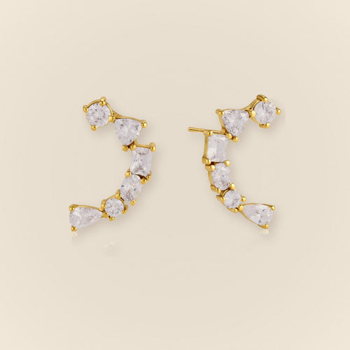 Ilo Smile Pave Stud Earrings on warm neutral background