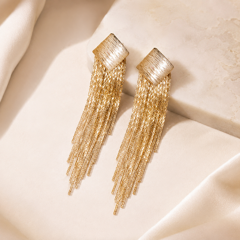 Close view of Virta Cascade Gold Earrings with sculptural line detail