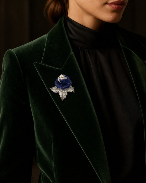Aava rose brooch at its true 5.6 by 5.9 centimetre scale on a green velvet lapel