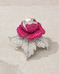 Aava Pearl Crystal Rose Brooch in silver tone and fuchsia on limestone