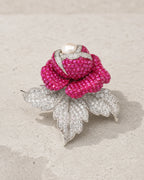 Aava Pearl Crystal Rose Brooch in silver tone and fuchsia on limestone