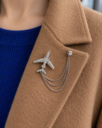 Aero Airplane Lapel Chain Brooch in silver-tone finish; close wearing view on a structured lapel