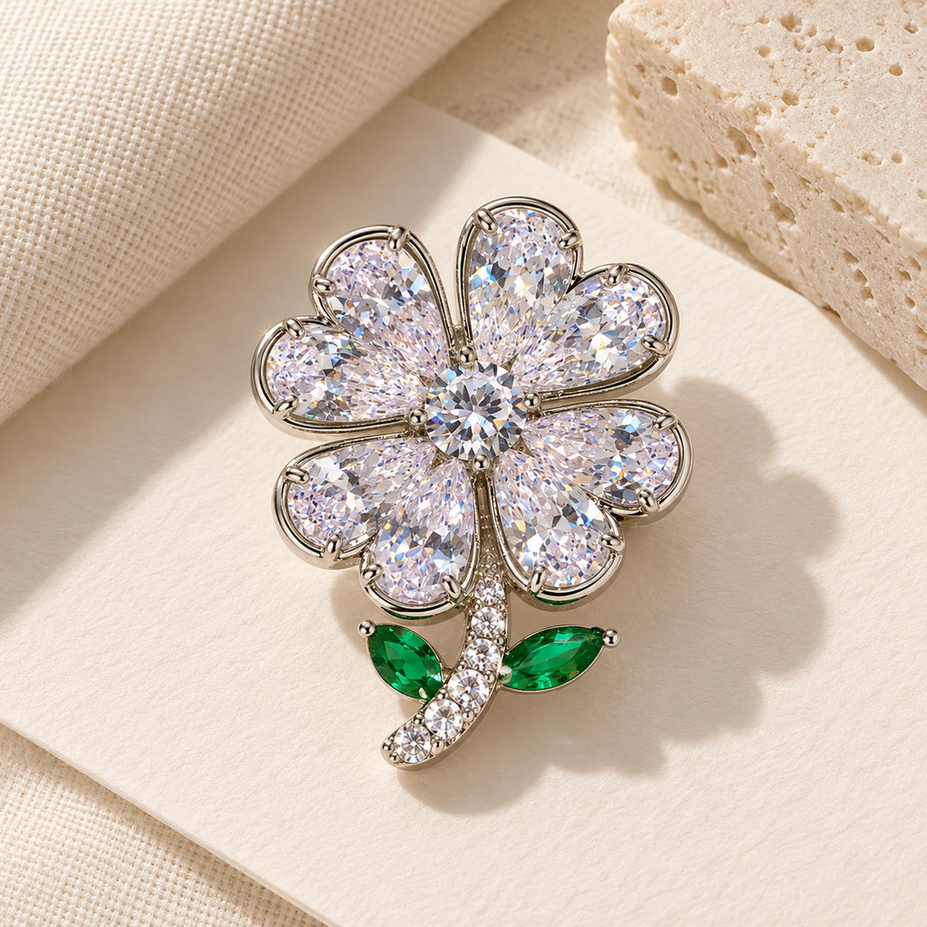 Complete Aili Clear Zircon Clover Brooch in an original still life on ivory paper.