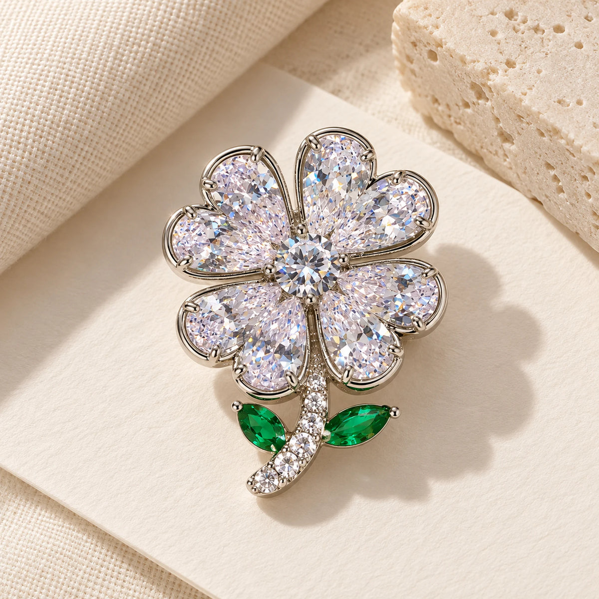 Complete Aili Clear Zircon Clover Brooch in an original still life on ivory paper.