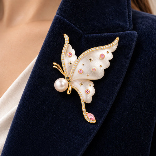 Aina butterfly brooch fastened fully within a broad folded navy velvet lapel.