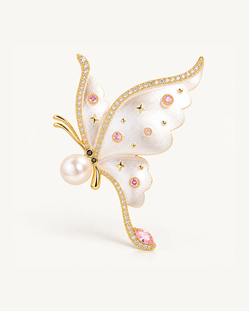 Aina Pearl-Look Enamel Butterfly Brooch in White and Gold, with pink accents and a curved trailing tip.