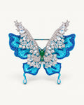 Front view of Airi Layered Blue Butterfly Brooch with turquoise sculpted wings, clear raised wings and two teardrop tails.