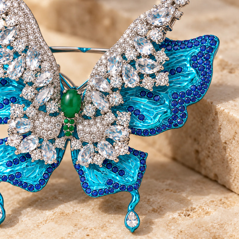 Close detail of the green oval centre, clear stone settings and sculpted turquoise wing.