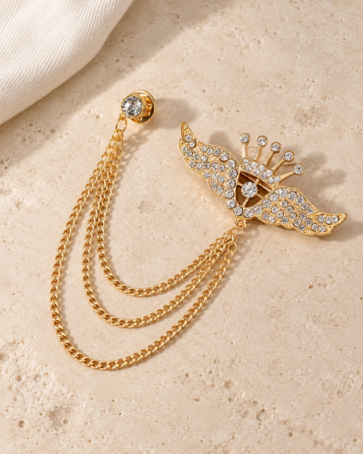 Alar Winged Crown Lapel Chain Brooch in gold-tone finish; still-life view showing the full drape