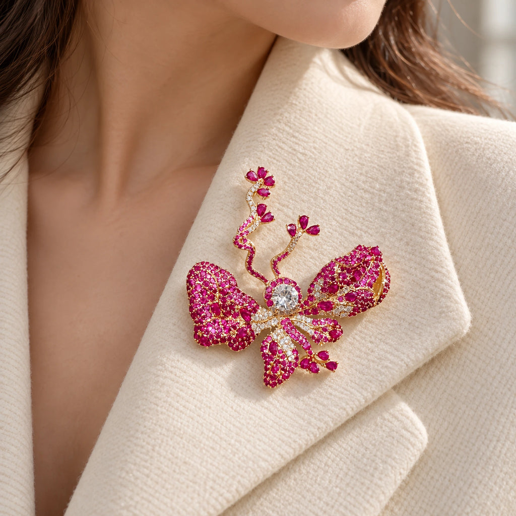 The rose-pink butterfly sits fully inside an ivory folded lapel.