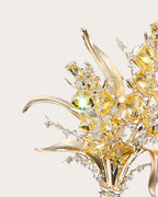 Detail of Aurea curved polished leaves, yellow zircon accents and slender gold-tone stems