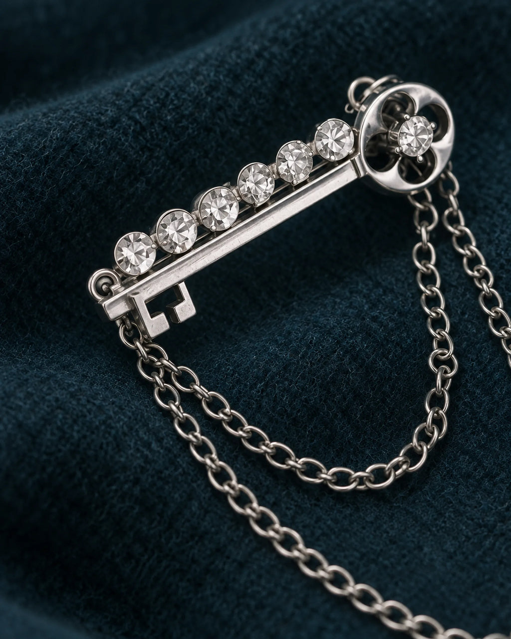 Avain Key Double Chain Brooch in silver-tone finish — detail study of the motif and chains
