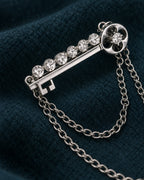 Avain Key Double Chain Brooch in silver-tone finish — detail study of the motif and chains