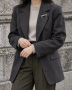 Avain Key Double Chain Brooch in silver-tone finish — wider wearing view with neutral tailoring