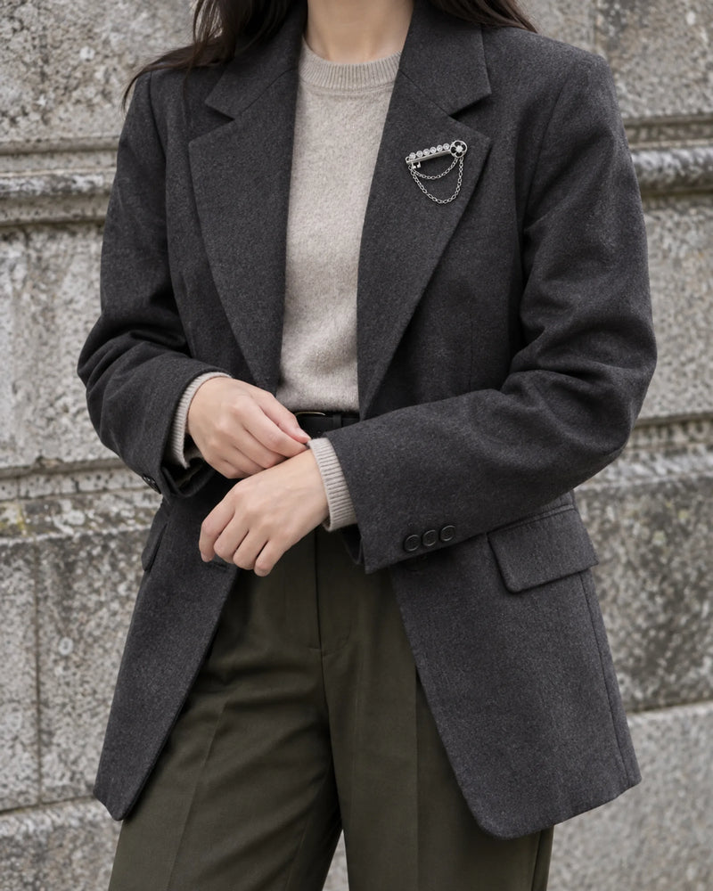 Avain Key Double Chain Brooch in silver-tone finish — wider wearing view with neutral tailoring