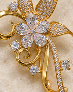Detail of Avelia clear pear-cut petals, pavé leaves and polished gold-tone scroll