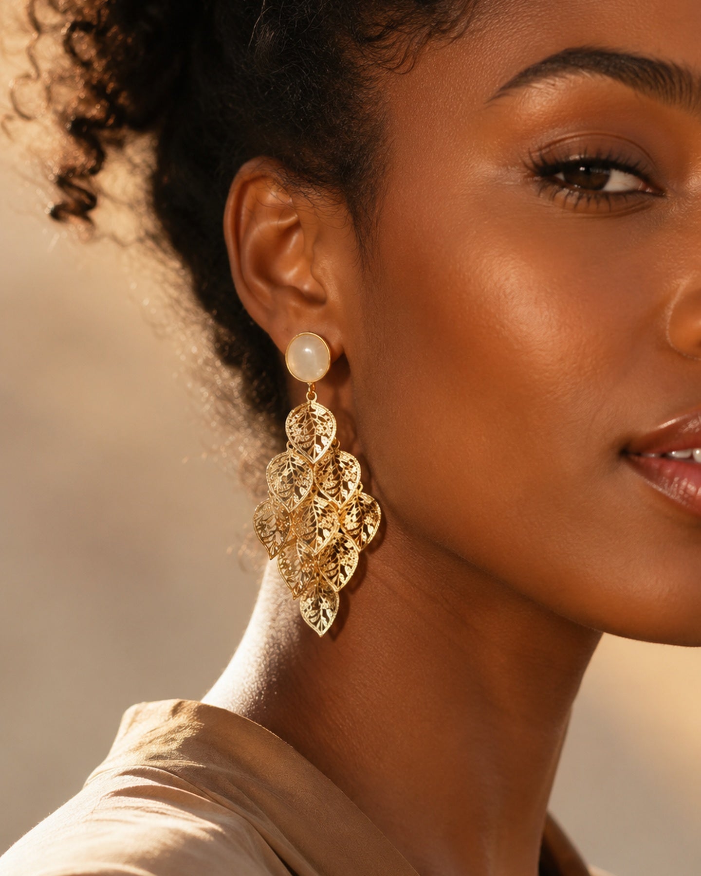 Lehti Gold Leaf Earrings with cascading leaf-shaped gold-tone drops