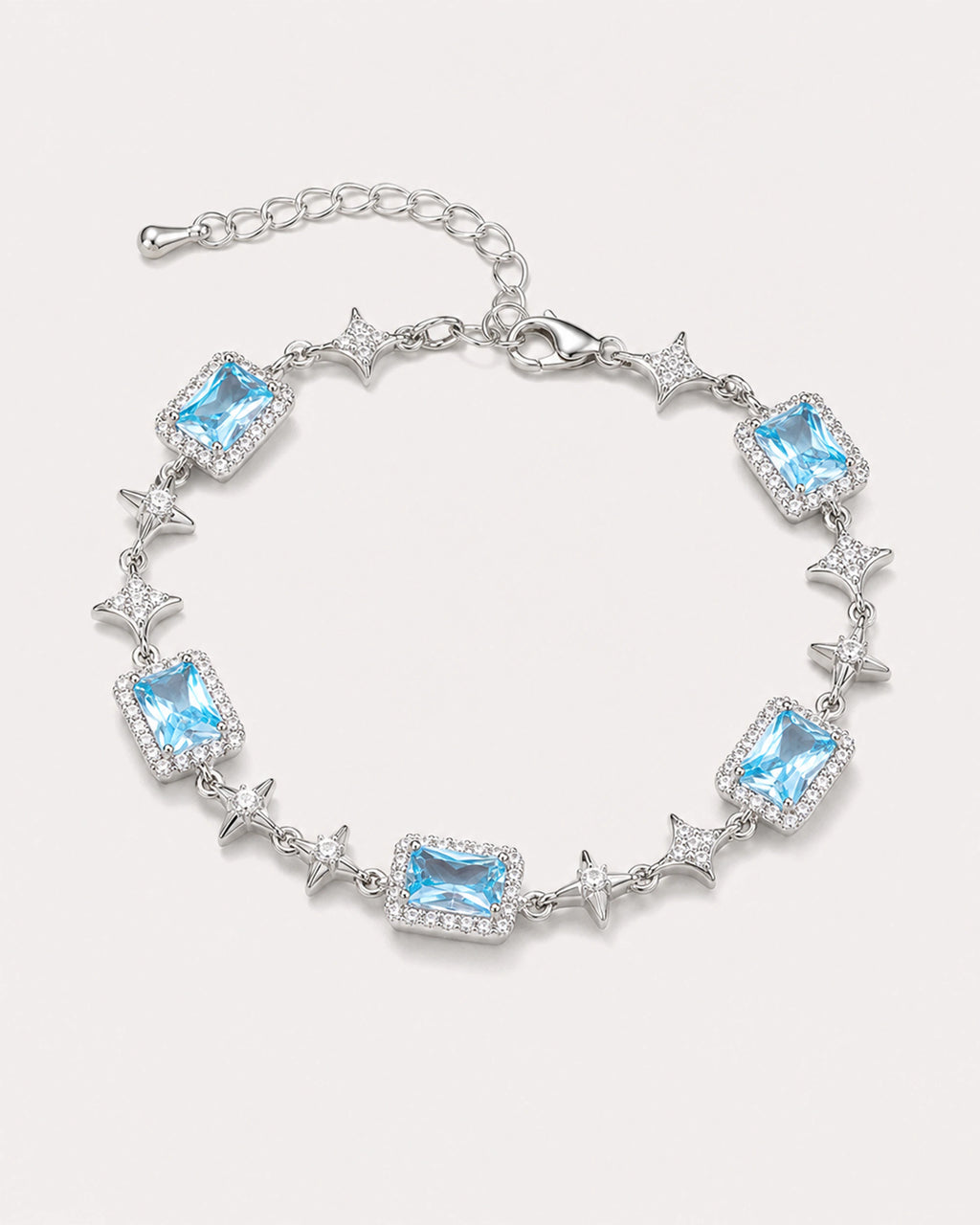 Celeste Blue Zircon Star Bracelet arranged on a warm #F0EBE9 studio background with natural contact shadow.