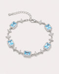 Celeste Blue Zircon Star Bracelet arranged on a warm #F0EBE9 studio background with natural contact shadow.