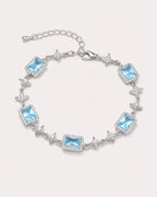 Celeste Blue Zircon Star Bracelet arranged on a warm #F0EBE9 studio background with natural contact shadow.