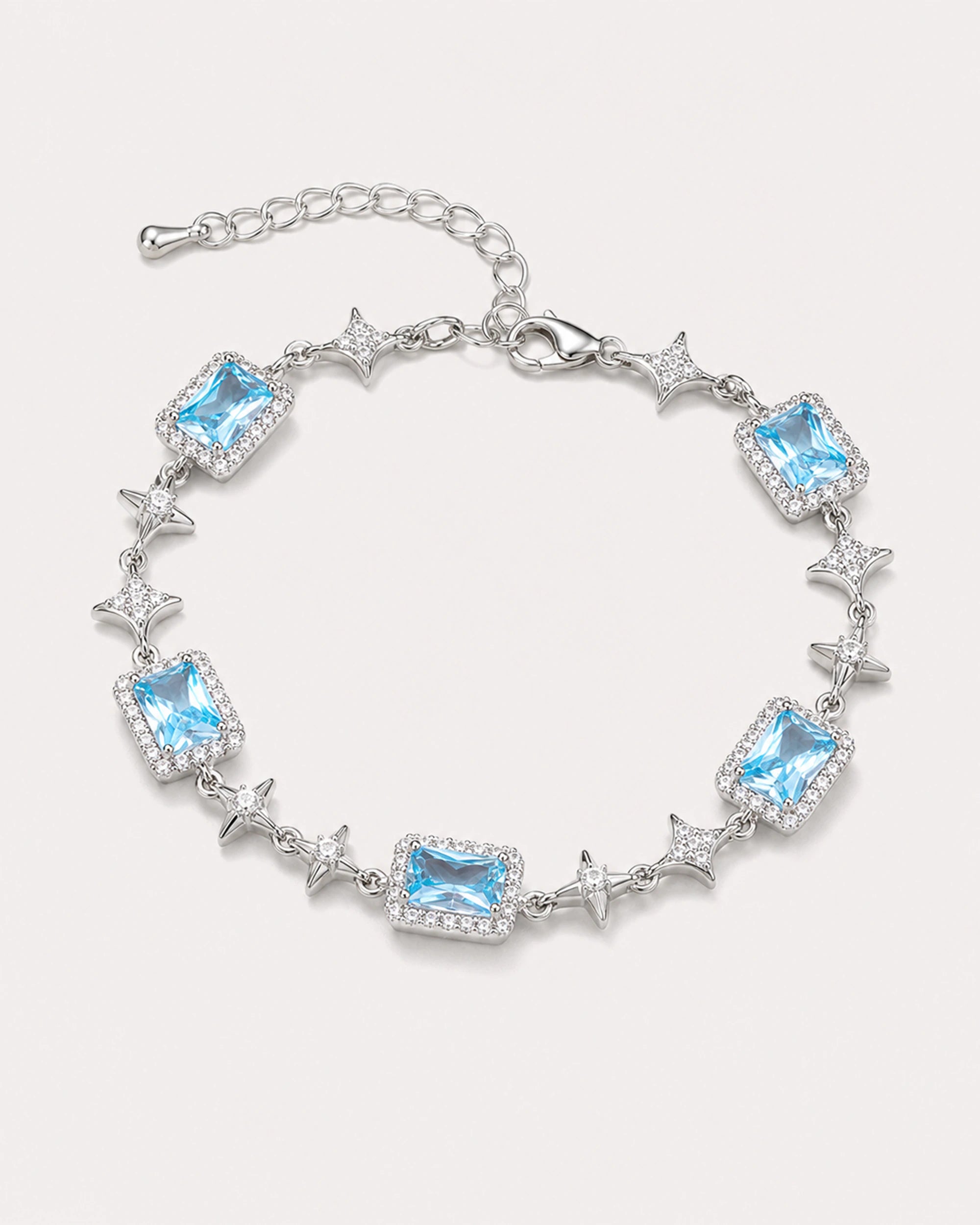 Celeste Blue Zircon Star Bracelet arranged on a warm #F0EBE9 studio background with natural contact shadow.