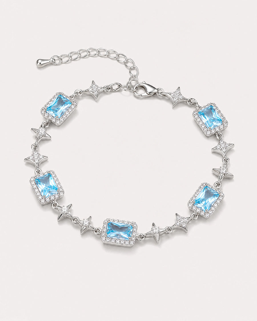 Celeste Blue Zircon Star Bracelet arranged on a warm #F0EBE9 studio background with natural contact shadow.