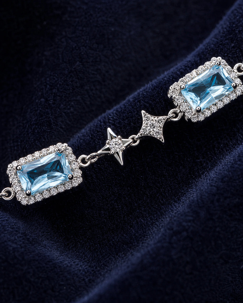Macro view of a rectangular blue zircon center, clear halo and four-point star link on the Celeste bracelet.