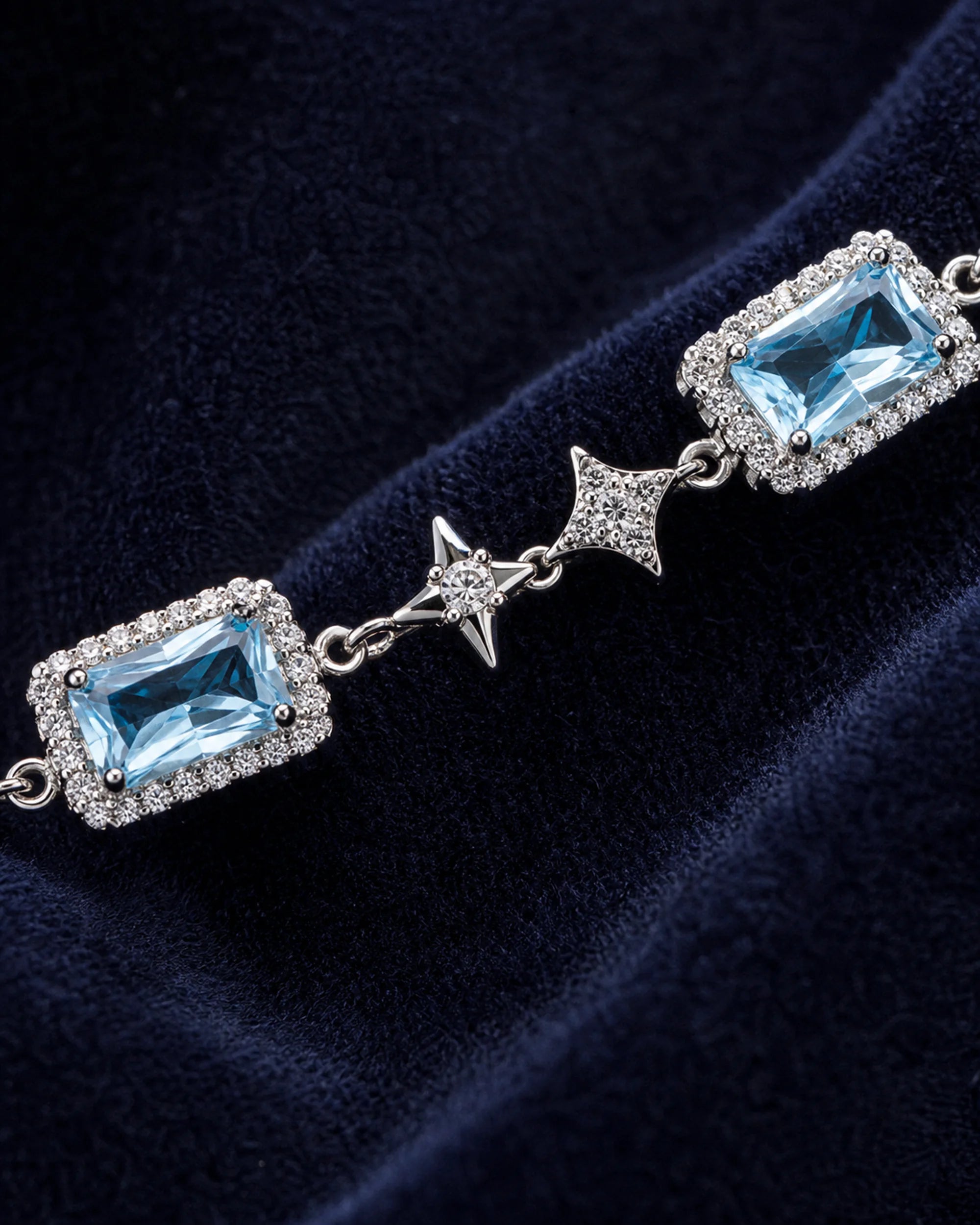 Macro view of a rectangular blue zircon center, clear halo and four-point star link on the Celeste bracelet.