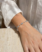 Close wrist view of the Celeste Blue Zircon Star Bracelet showing five blue zircon centers and four-point star links.